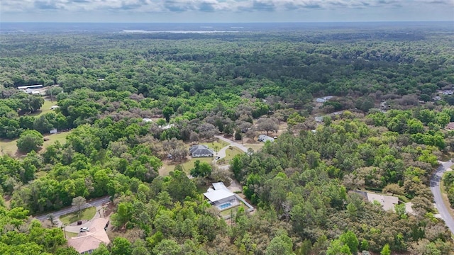 drone / aerial view featuring a view of trees