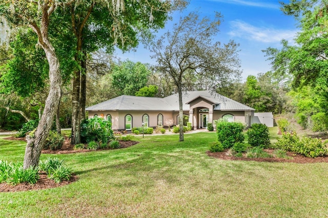 single story home with a front lawn and stucco siding