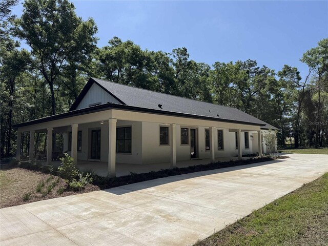 18890 SW 60th St, Dunnellon, FL 34432 - view of front of house featuring a porch and concrete driveway