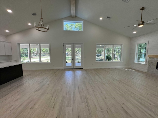 18890 SW 60th St, Dunnellon, FL 34432 - unfurnished living room with visible vents, high vaulted ceiling, french doors, and light wood-style flooring