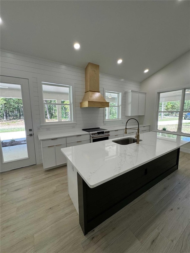 18890 SW 60th St, Dunnellon, FL 34432 - kitchen featuring white cabinetry, custom range hood, a sink, a spacious island, and electric stove