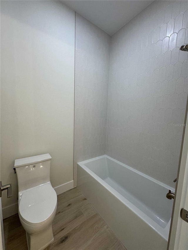 18890 SW 60th St, Dunnellon, FL 34432 - bathroom featuring baseboards, wood finished floors, and toilet