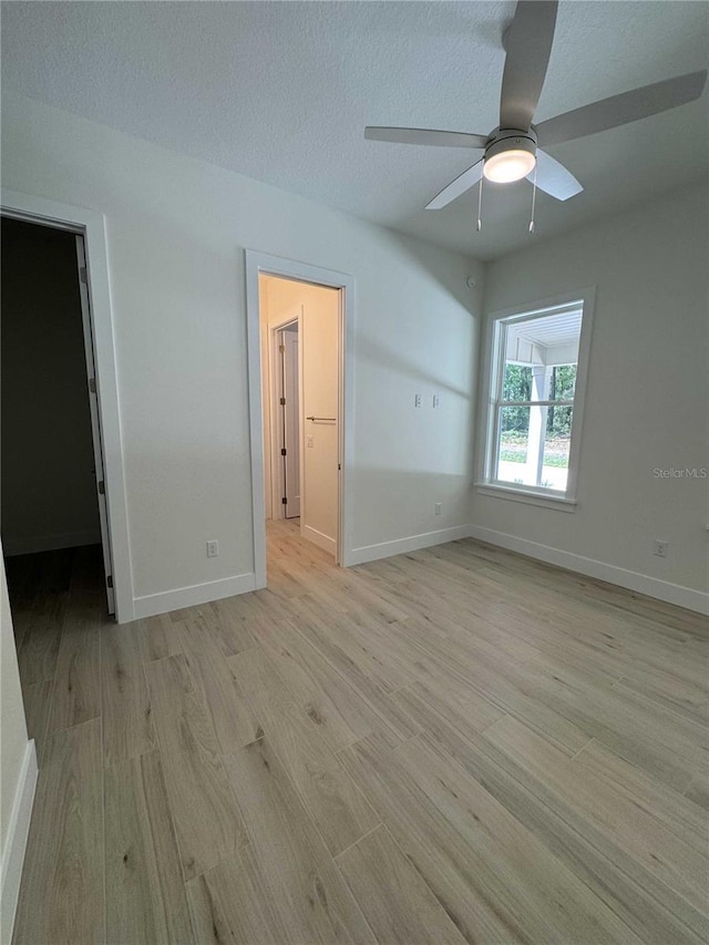 18890 SW 60th St, Dunnellon, FL 34432 - interior space with a walk in closet, ceiling fan, light wood-style flooring, and baseboards