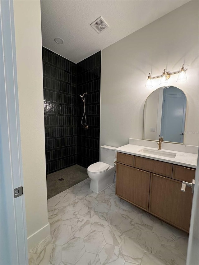 18890 SW 60th St, Dunnellon, FL 34432 - full bath featuring visible vents, toilet, vanity, marble finish floor, and tiled shower