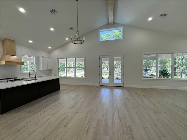 18890 SW 60th St, Dunnellon, FL 34432 - unfurnished living room featuring beam ceiling, visible vents, high vaulted ceiling, and a sink
