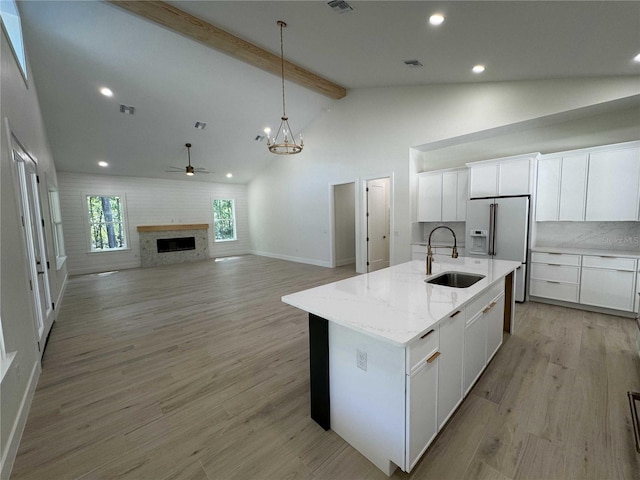 18890 SW 60th St, Dunnellon, FL 34432 - kitchen with beamed ceiling, a sink, baseboards, recessed lighting, and ceiling fan with notable chandelier
