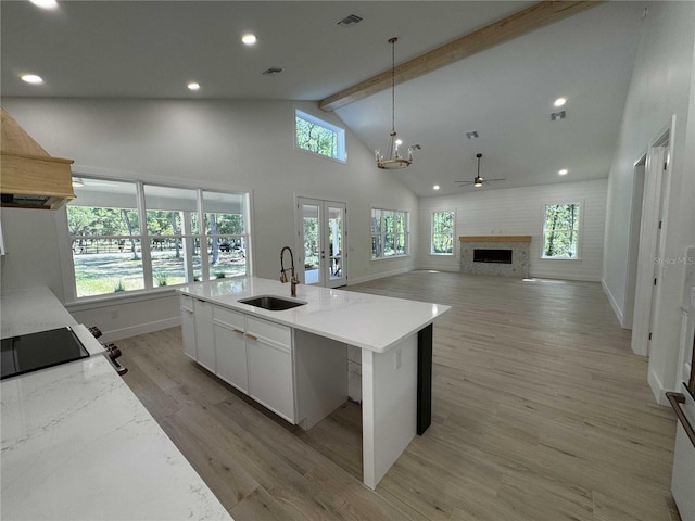 18890 SW 60th St, Dunnellon, FL 34432 - kitchen featuring light wood-style flooring, beamed ceiling, a sink, visible vents, and pendant lighting