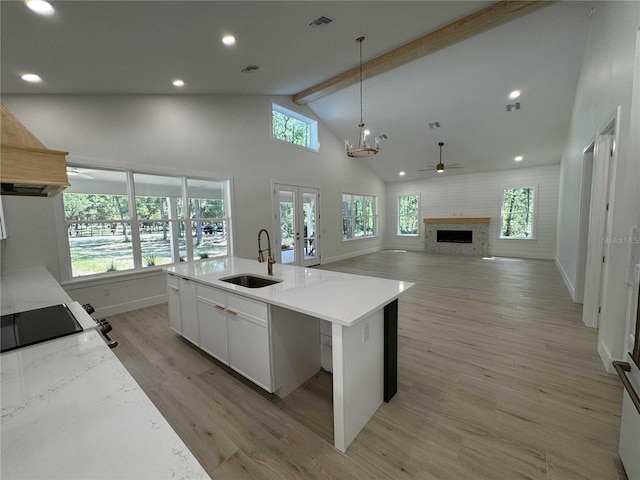 18890 SW 60th St, Dunnellon, FL 34432 - kitchen featuring beamed ceiling, light wood finished floors, a sink, high vaulted ceiling, and pendant lighting