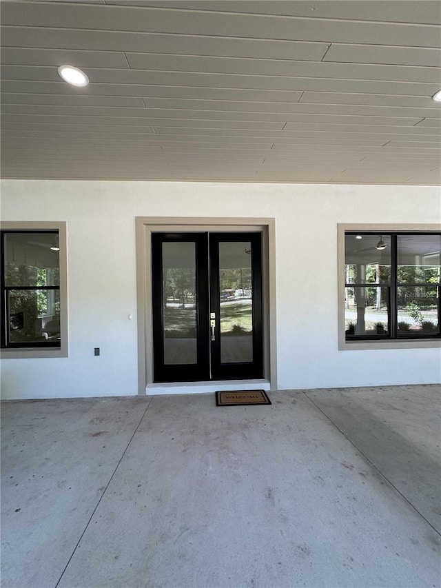 18890 SW 60th St, Dunnellon, FL 34432 - view of exterior entry featuring stucco siding, a patio area, and french doors