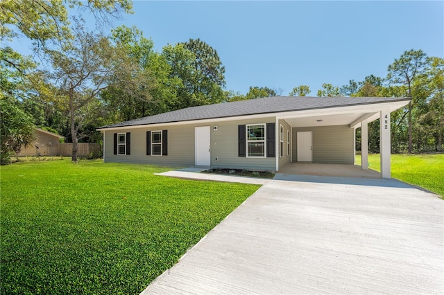 1074 SE 52nd St, Keystone Heights, FL 32656 - ranch-style house featuring a front yard, driveway, an attached carport, and fence