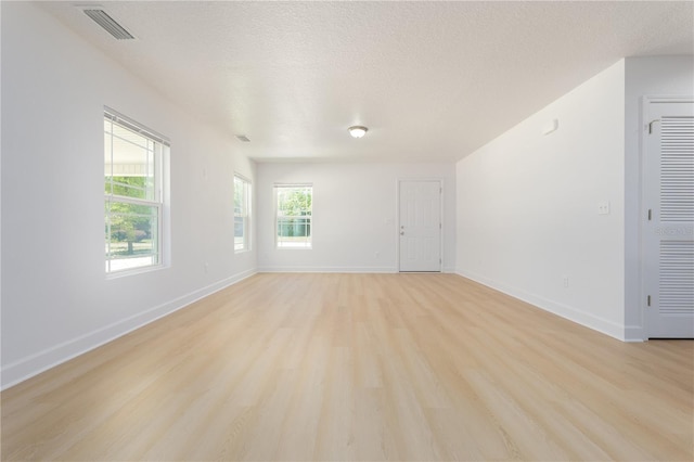 1074 SE 52nd St, Keystone Heights, FL 32656 - empty room featuring baseboards, visible vents, a textured ceiling, and light wood-style flooring