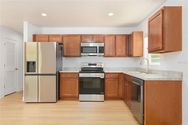 1074 SE 52nd St, Keystone Heights, FL 32656 - kitchen featuring light wood finished floors, a sink, appliances with stainless steel finishes, and light countertops