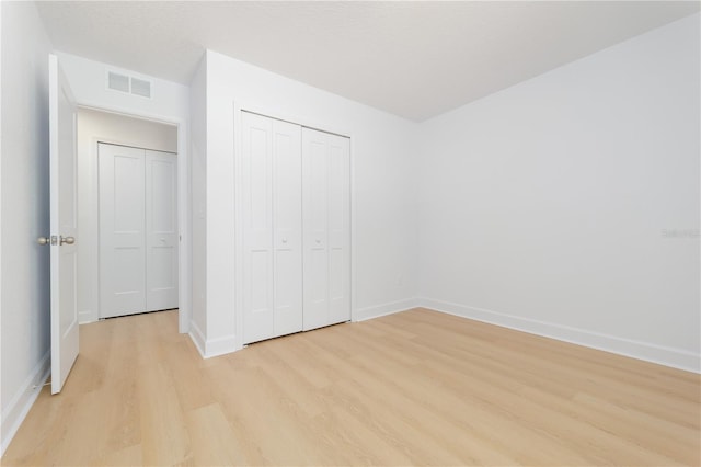1074 SE 52nd St, Keystone Heights, FL 32656 - unfurnished bedroom featuring visible vents, light wood-type flooring, a closet, and baseboards