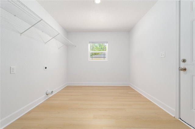 1074 SE 52nd St, Keystone Heights, FL 32656 - washroom with hookup for an electric dryer, light wood finished floors, laundry area, and baseboards