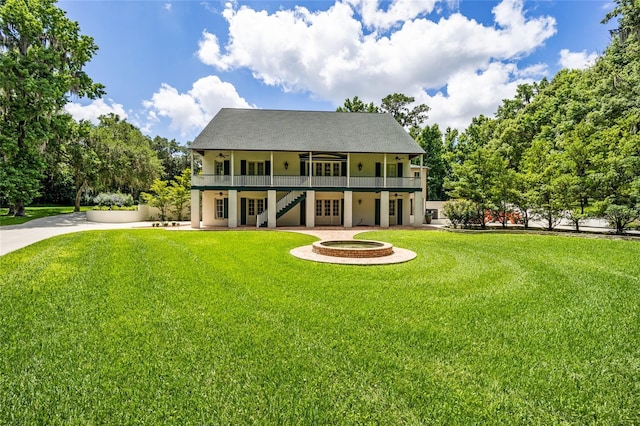 950 SW 43rd Pl, Ocala, FL 34471 - back of house featuring driveway, stucco siding, stairs, a ceiling fan, and a yard