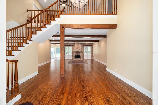 950 SW 43rd Pl, Ocala, FL 34471 - unfurnished living room featuring stairs, beam ceiling, baseboards, and wood finished floors