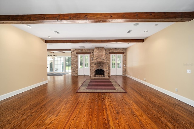 950 SW 43rd Pl, Ocala, FL 34471 - unfurnished living room with a healthy amount of sunlight, beam ceiling, and wood finished floors