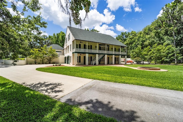 950 SW 43rd Pl, Ocala, FL 34471 - view of front of property with a ceiling fan, stairs, stucco siding, and a front yard