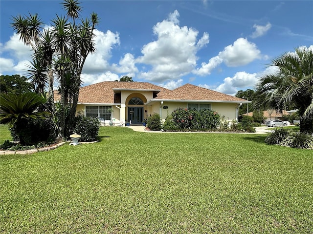 14 SE 62nd Ter, Ocala, FL 34471 - mediterranean / spanish house with stucco siding, a front lawn, and french doors