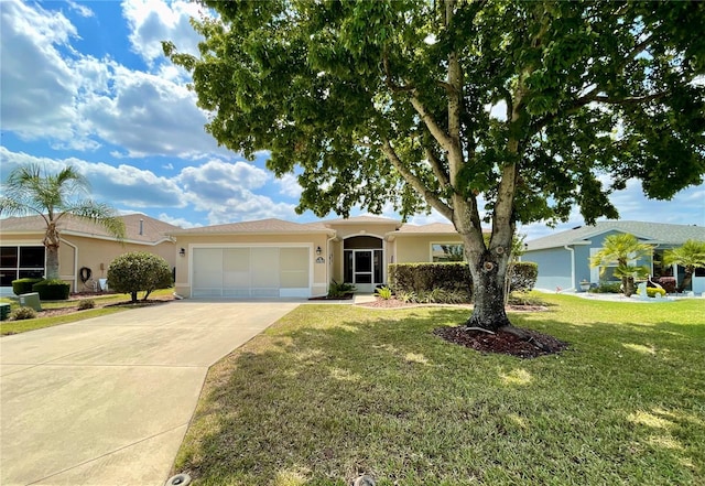 15782 SW 16th Avenue Rd, Ocala, FL 34473 - single story home with a garage, driveway, a front yard, and stucco siding