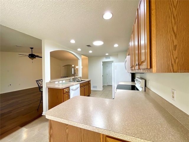 15782 SW 16th Avenue Rd, Ocala, FL 34473 - kitchen with brown cabinets, white appliances, a ceiling fan, and a sink