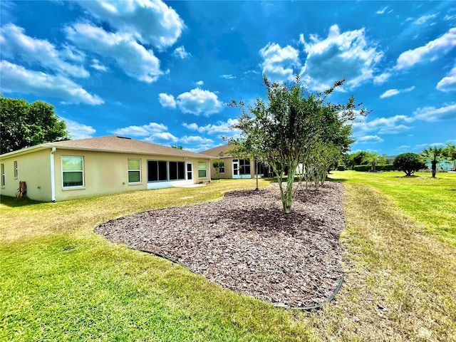 15782 SW 16th Avenue Rd, Ocala, FL 34473 - rear view of house featuring stucco siding and a lawn