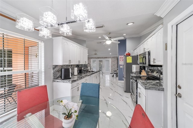 kitchen featuring appliances with stainless steel finishes, tasteful backsplash, crown molding, and white cabinets