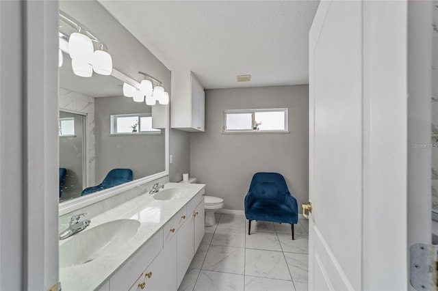 full bath featuring visible vents, marble finish floor, toilet, and a sink