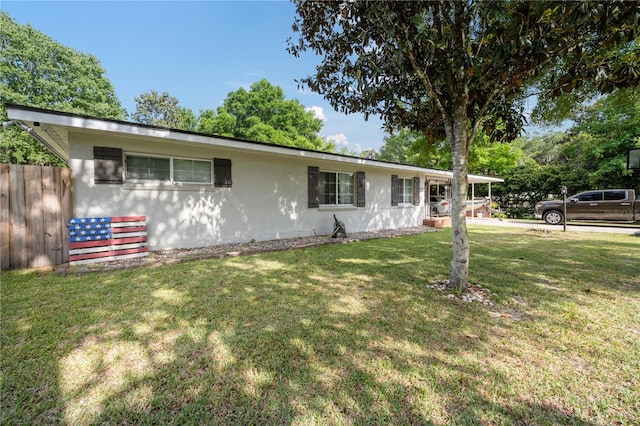 219 NW 7th St, Williston, FL 32696 - single story home featuring stucco siding, fence, and a front lawn