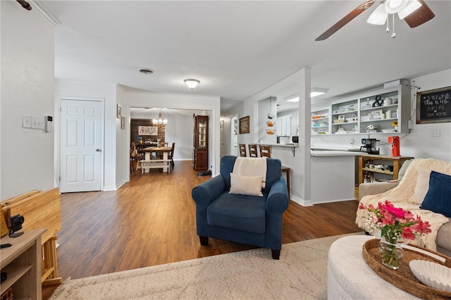 219 NW 7th St, Williston, FL 32696 - living area with baseboards, ceiling fan with notable chandelier, and wood finished floors