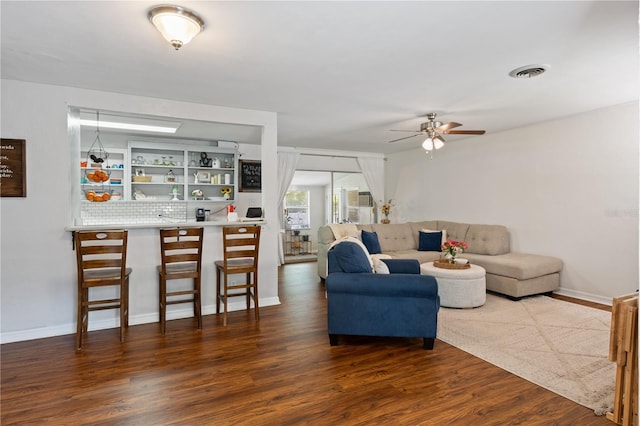 219 NW 7th St, Williston, FL 32696 - living room with baseboards, a ceiling fan, wood finished floors, and visible vents