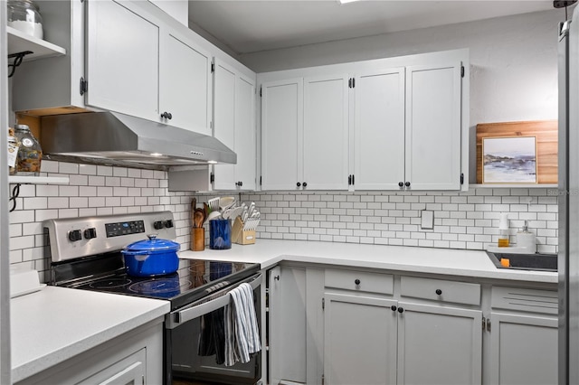 219 NW 7th St, Williston, FL 32696 - kitchen with electric stove, under cabinet range hood, tasteful backsplash, and light countertops