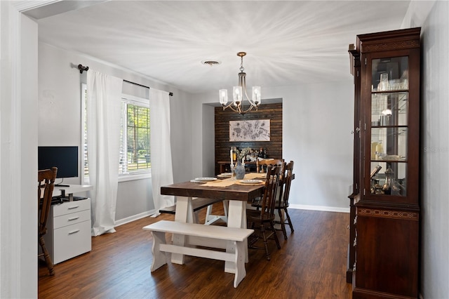 219 NW 7th St, Williston, FL 32696 - dining room with baseboards, dark wood finished floors, an inviting chandelier, and visible vents