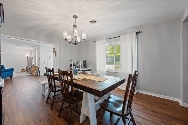 219 NW 7th St, Williston, FL 32696 - dining area featuring visible vents, baseboards, dark wood-style floors, and an inviting chandelier