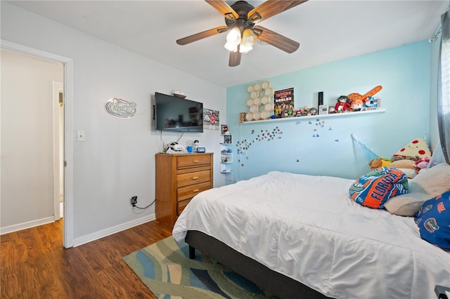 219 NW 7th St, Williston, FL 32696 - bedroom with baseboards, ceiling fan, and wood finished floors