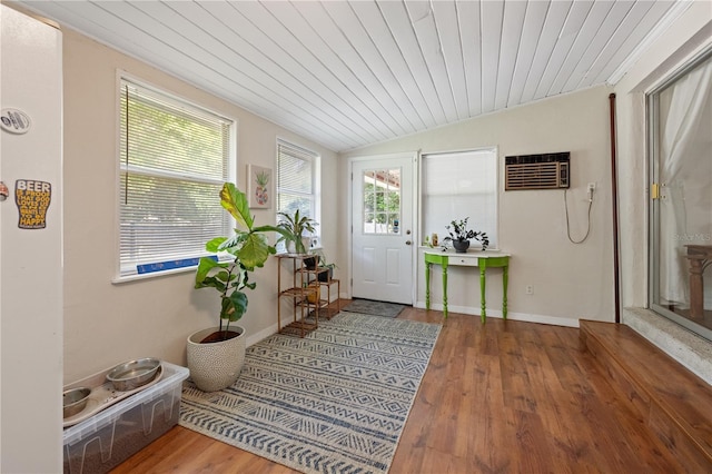 219 NW 7th St, Williston, FL 32696 - entryway featuring wood ceiling, vaulted ceiling, a wall mounted air conditioner, wood finished floors, and baseboards
