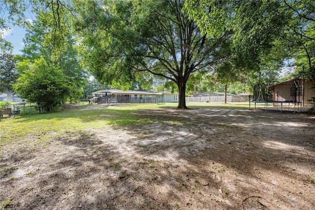 219 NW 7th St, Williston, FL 32696 - view of yard with a fenced backyard and a trampoline