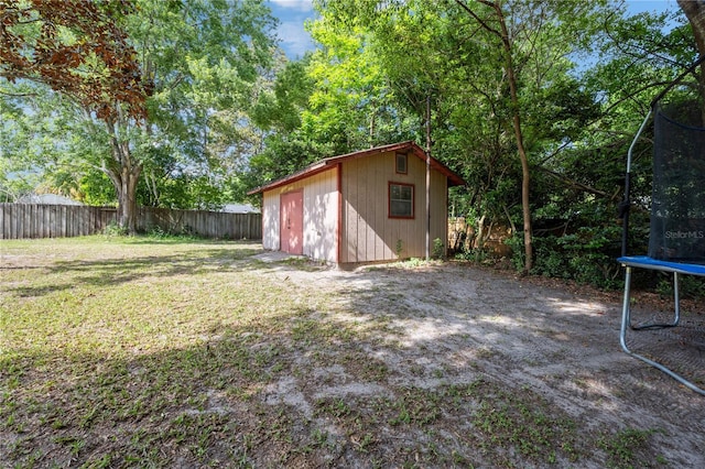 219 NW 7th St, Williston, FL 32696 - view of yard featuring fence, an outbuilding, a trampoline, and a storage unit
