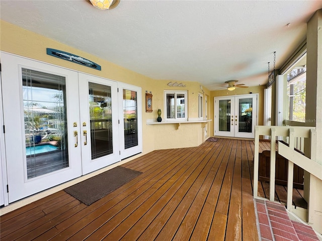 wooden deck featuring ceiling fan and french doors