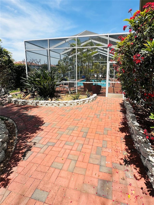 view of patio / terrace with a lanai and an outdoor pool