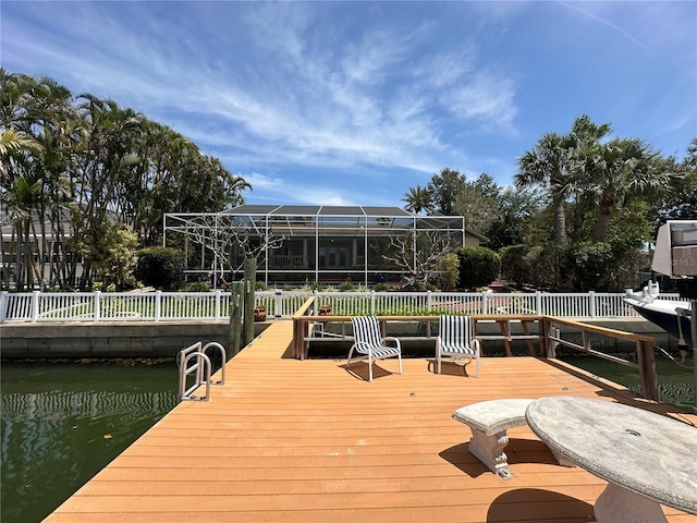 view of dock featuring glass enclosure and a water view
