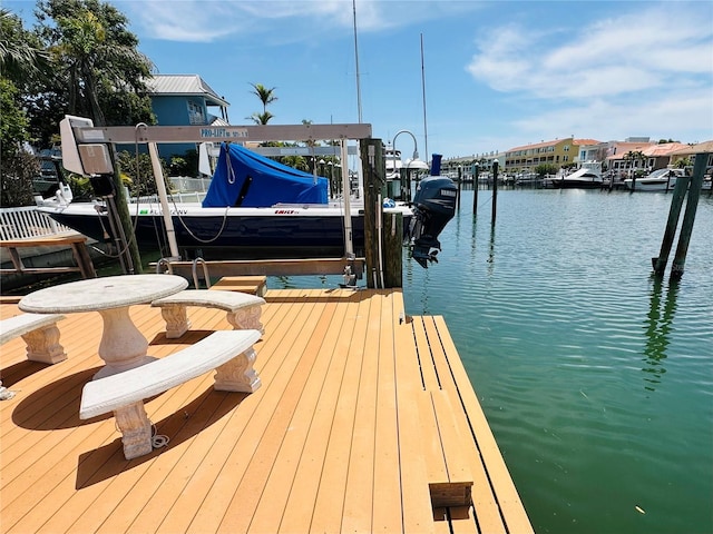 dock area with boat lift and a water view