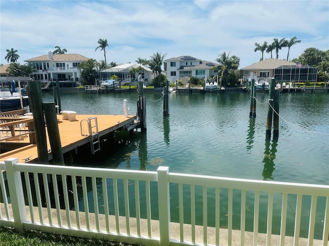 view of dock featuring a water view and a residential view