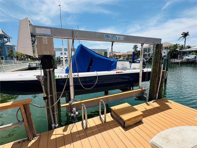 view of dock featuring boat lift and a water view