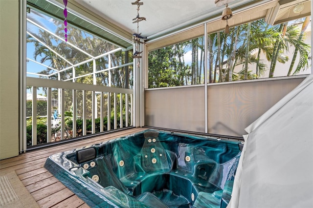 unfurnished sunroom featuring a jacuzzi and a healthy amount of sunlight