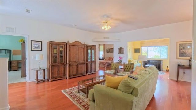 2323 NW 55th Avenue Rd, Ocala, FL 34482 - living area featuring light wood finished floors, ceiling fan, and baseboards