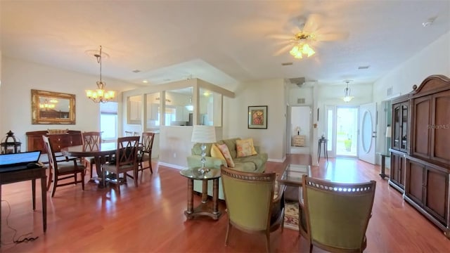 2323 NW 55th Avenue Rd, Ocala, FL 34482 - living room featuring wood finished floors, a chandelier, and ceiling fan