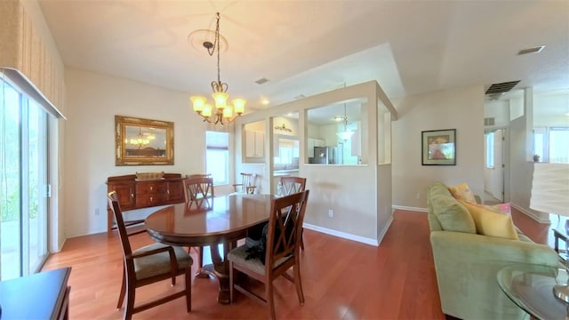 2323 NW 55th Avenue Rd, Ocala, FL 34482 - dining area featuring wood finished floors, a chandelier, and baseboards
