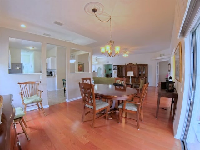 2323 NW 55th Avenue Rd, Ocala, FL 34482 - dining area with light wood finished floors, a chandelier, and baseboards