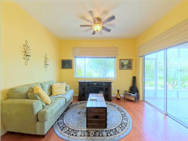2323 NW 55th Avenue Rd, Ocala, FL 34482 - living area with a ceiling fan, plenty of natural light, wood finished floors, and baseboards